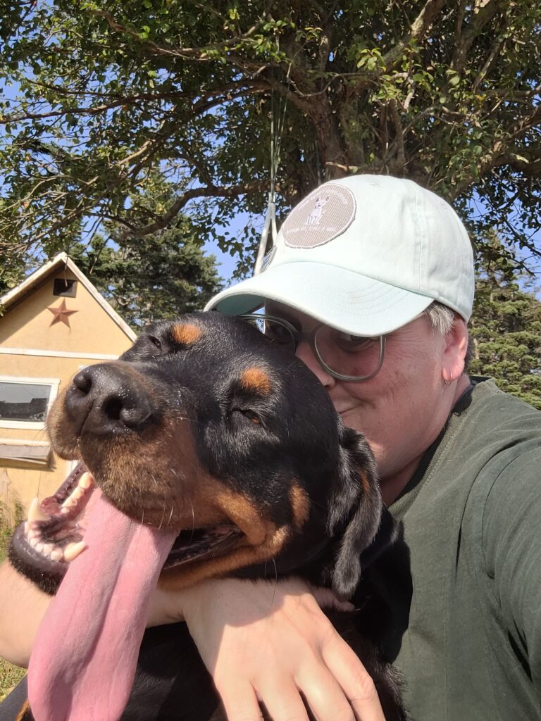 Luna getting a hug from Mama Your Happy Dog Coach