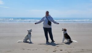 Your Happy Dog Coach Lori-Lee Regimbald with her two northern Canadian Rescue Pups Kitchi and Casey at Bartlett's Beach Nova Scotia